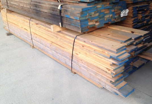 Photo - Australian Cypress lumber planks, rough sawn, stacked. ©all rights reserved.