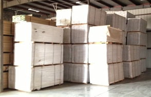 Photo - stacks of PRE-finished Australian Cypress flooring packaged in cartons, wholesale quantities. 